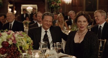 Movie still from “The Company Men” (2010), directed by John Wells – A man and a woman sitting at a dinner table; Medium shot, Over the shoulder angle