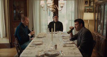 Movie still from “The Company Men” (2010), directed by John Wells – A group of men sitting at a table drinking beer; Medium shot, Over the shoulder angle