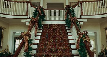 Movie still from “The Company Men” (2010), directed by John Wells – The stairs are decorated for the holiday season; Extreme Wide shot, High angle