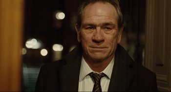Movie still from “The Company Men” (2010), directed by John Wells – An older man wearing a suit and a tie; Close Up shot, Over the shoulder angle