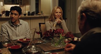 Movie still from “The Company Men” (2010), directed by John Wells – A woman sitting at a table with a glass of red wine; Medium shot, Over the shoulder angle