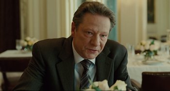 Movie still from “The Company Men” (2010), directed by John Wells – A person wearing a suit and tie; Close Up shot, Over the shoulder angle