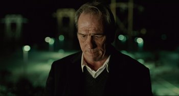 Movie still from “The Company Men” (2010), directed by John Wells – An older man in a black jacket is looking down; Close Up shot, Low angle