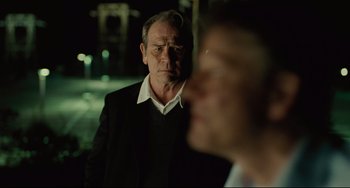 Movie still from “The Company Men” (2010), directed by John Wells – An older man in a black jacket and a younger man in a white shirt; Close Up shot, Over the shoulder angle