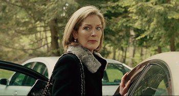 Movie still from “The Company Men” (2010), directed by John Wells – A woman in a black coat and a scarf; Close Up shot, Over the shoulder angle