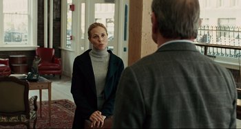Movie still from “The Company Men” (2010), directed by John Wells – A woman in a gray jacket and a man in a gray suit; Medium shot, Over the shoulder angle