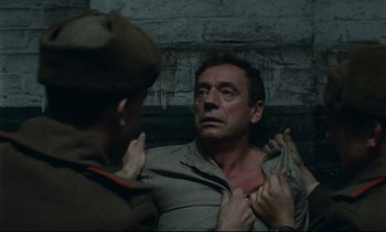 Movie still from “The Confession” (1970), directed by Costa-Gavras – A man in a uniform and a woman in a military uniform; Close Up shot, High angle