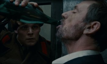 Movie still from “The Confession” (1970), directed by Costa-Gavras – A man in a military uniform putting something in his mouth; Close Up shot, Over the shoulder angle