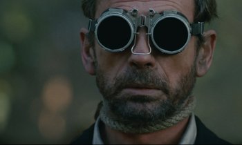 Movie still from “The Confession” (1970), directed by Costa-Gavras – A person wearing a pair of goggles; Close Up shot, Low angle