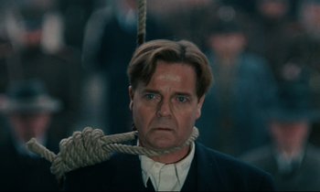 Movie still from “The Confession” (1970), directed by Costa-Gavras – A person with a rope around his neck; Close Up shot, Low angle