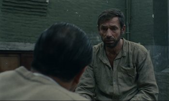 Movie still from “The Confession” (1970), directed by Costa-Gavras – A man sitting in front of a mirror looking at himself in the mirror; Close Up shot, Over the shoulder angle