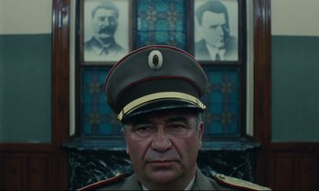 Movie still from “The Confession” (1970), directed by Costa-Gavras – A person wearing a military uniform; Close Up shot, Low angle