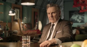 Movie still from “The Congress” (2013), directed by Ari Folman – An older man sitting at a table with a glass of water; Close Up shot, Low angle