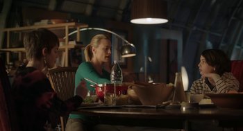 Movie still from “The Congress” (2013), directed by Ari Folman – A woman sitting at a table with a bowl of food; Medium shot, Over the shoulder angle