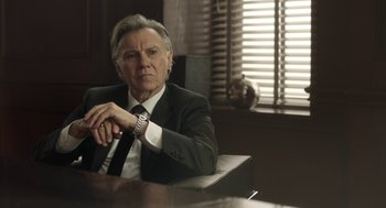 Movie still from “The Congress” (2013), directed by Ari Folman – A man in a suit and tie sitting at a table; Close Up shot, Low angle