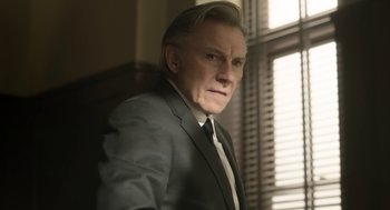 Movie still from “The Congress” (2013), directed by Ari Folman – A man in a suit and tie standing in front of a window; Close Up shot, Low angle