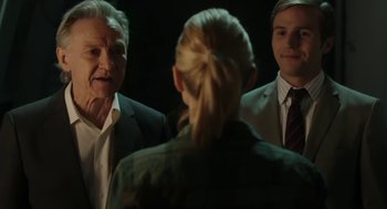 Movie still from “The Congress” (2013), directed by Ari Folman – A group of men standing next to each other in front of a mirror; Medium shot, Over the shoulder angle