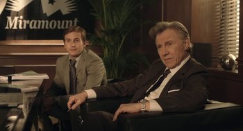 Movie still from “The Congress” (2013), directed by Ari Folman – Two men in suits and ties sitting in a room; Medium shot, Low angle