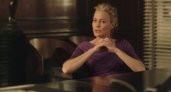 Movie still from “The Congress” (2013), directed by Ari Folman – A woman sitting at a table with her hand on her chin; Medium shot, Over the shoulder angle