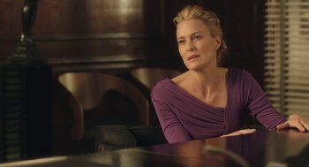 Movie still from “The Congress” (2013), directed by Ari Folman – A woman sitting at a table in front of a window; Close Up shot, Over the shoulder angle