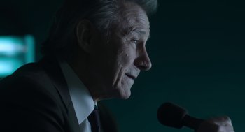 Movie still from “The Congress” (2013), directed by Ari Folman – An older man is speaking at a microphone; Close Up shot, Low angle