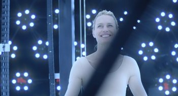 Movie still from “The Congress” (2013), directed by Ari Folman – A woman standing in front of a stage with lights in the background; Close Up shot, Low angle