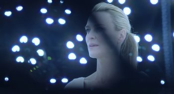 Movie still from “The Congress” (2013), directed by Ari Folman – A beautiful woman with a ponytail standing in front of a bunch of lights; Close Up shot, Over the shoulder angle