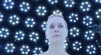 Movie still from “The Congress” (2013), directed by Ari Folman – A woman standing in front of a bunch of lights; Close Up shot, Low angle