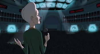 Movie still from “The Congress” (2013), directed by Ari Folman – An older woman holding a microphone in front of an audience; Wide shot, Over the shoulder angle