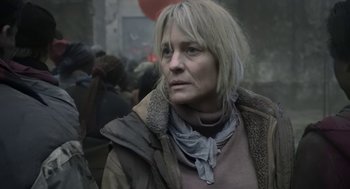 Movie still from “The Congress” (2013), directed by Ari Folman – A woman in a brown jacket is looking at the camera; Close Up shot, Over the shoulder angle