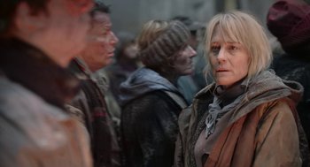 Movie still from “The Congress” (2013), directed by Ari Folman – A group of people standing around each other in a crowd; Close Up shot, Over the shoulder angle