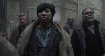 Movie still from “The Congress” (2013), directed by Ari Folman – A group of people walking down a street; Medium shot, Low angle