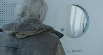 Movie still from “The Congress” (2013), directed by Ari Folman – A woman looking in the mirror of a doctor's office; Extreme Close Up shot, Over the shoulder angle