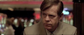 Movie still from “The Cooler” (2003), directed by Wayne Kramer – A person wearing a suit and tie; Close Up shot, Over the shoulder angle