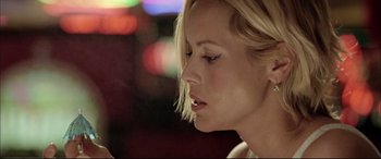 Movie still from “The Cooler” (2003), directed by Wayne Kramer – A woman with blonde hair looking down; Close Up shot, Low angle