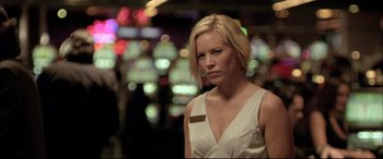 Movie still from “The Cooler” (2003), directed by Wayne Kramer – A woman in a white dress standing next to a building; Close Up shot, Low angle