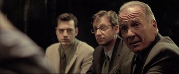 Movie still from “The Cooler” (2003), directed by Wayne Kramer – A group of men sitting next to each other in a room; Close Up shot, Low angle