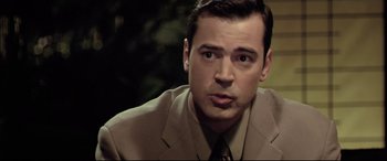 Movie still from “The Cooler” (2003), directed by Wayne Kramer – A person wearing a suit and tie; Close Up shot, High angle