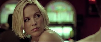 Movie still from “The Cooler” (2003), directed by Wayne Kramer – A person sitting in a room; Close Up shot, Low angle