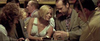 Movie still from “The Cooler” (2003), directed by Wayne Kramer – A man and a woman sitting at a table with drinks; Medium shot, Over the shoulder angle
