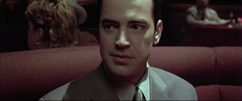 Movie still from “The Cooler” (2003), directed by Wayne Kramer – A person wearing a suit and tie; Close Up shot, Over the shoulder angle