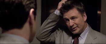 Movie still from “The Cooler” (2003), directed by Wayne Kramer – A man in a suit is combing his hair in front of a mirror; Close Up shot, Over the shoulder angle