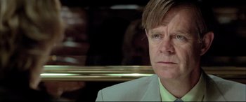 Movie still from “The Cooler” (2003), directed by Wayne Kramer – A person wearing a suit and tie; Close Up shot, Low angle