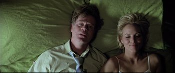 Movie still from “The Cooler” (2003), directed by Wayne Kramer – A man and a woman laying in a bed together; Medium shot, Overhead angle