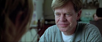 Movie still from “The Cooler” (2003), directed by Wayne Kramer – An older man wearing a hospital gown looking at the camera; Close Up shot, Over the shoulder angle