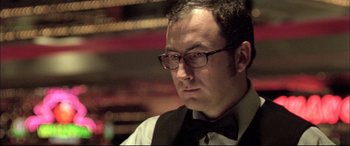 Movie still from “The Cooler” (2003), directed by Wayne Kramer – A person wearing glasses and a bow tie; Close Up shot, Low angle