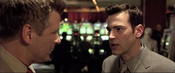 Movie still from “The Cooler” (2003), directed by Wayne Kramer – Two men are talking in front of a slot machine; Close Up shot, Over the shoulder angle