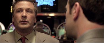 Movie still from “The Cooler” (2003), directed by Wayne Kramer – A man in a suit and tie talking to another man in a suit and tie; Close Up shot, Low angle