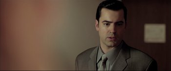 Movie still from “The Cooler” (2003), directed by Wayne Kramer – A person wearing a suit and tie; Close Up shot, Low angle
