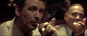 Movie still from “The Cooler” (2003), directed by Wayne Kramer – A person smoking a cigarette; Close Up shot, Low angle
